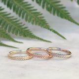 silver fern rings in yellow gold, rose gold, and white gold