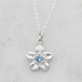 forget me not necklace with an aquamarine