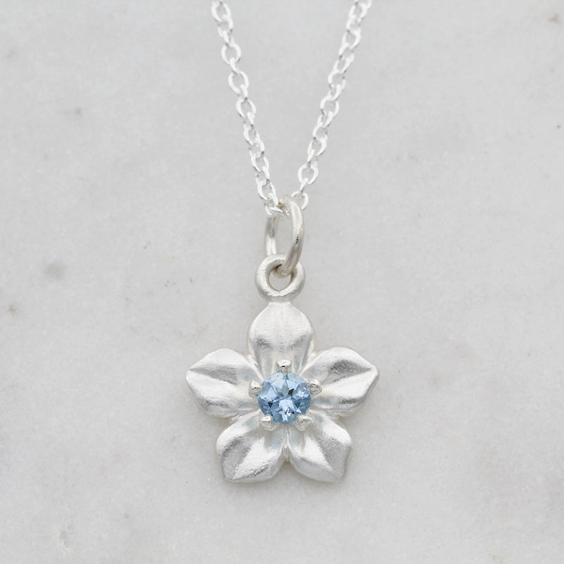 forget me not necklace with an aquamarine
