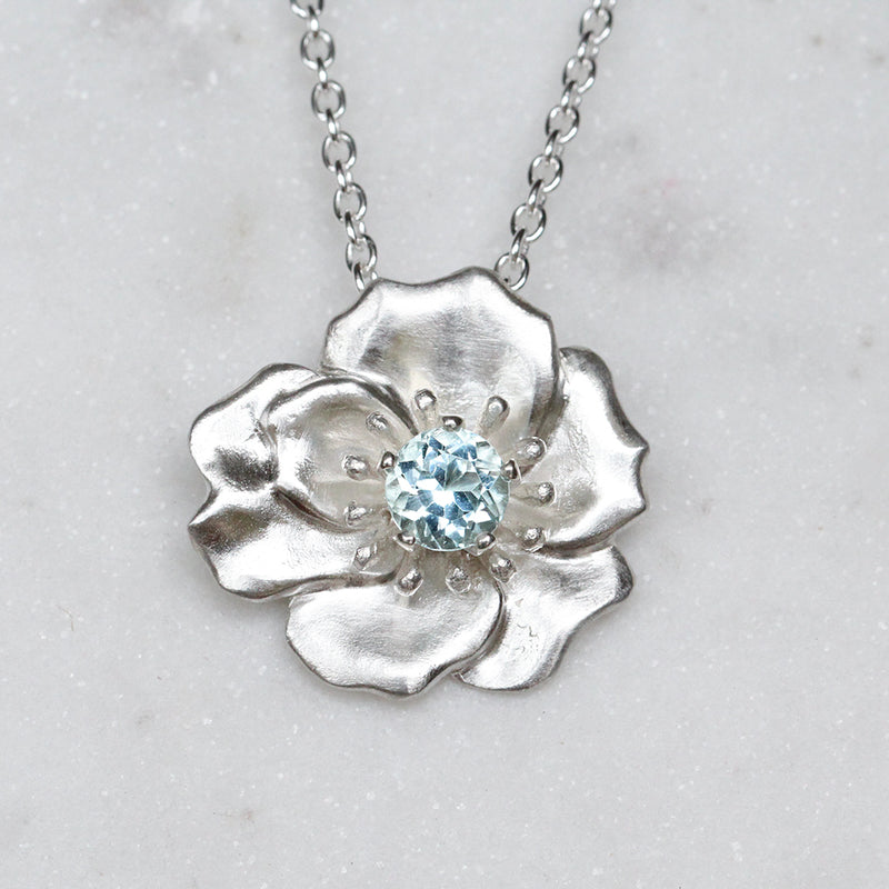 Eva rose necklace in silver set with an aquamarine