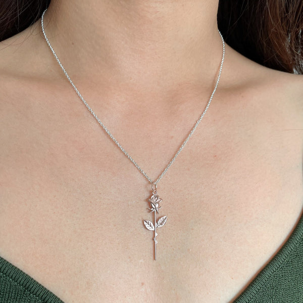 rose gold rose pendant on a silver chain