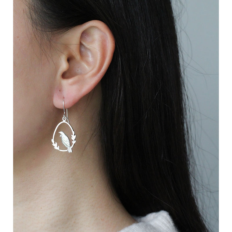 silver tui earrings